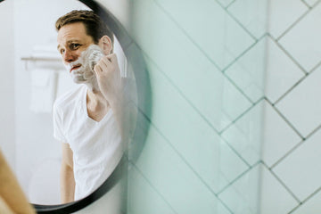 Man grooming in mirror