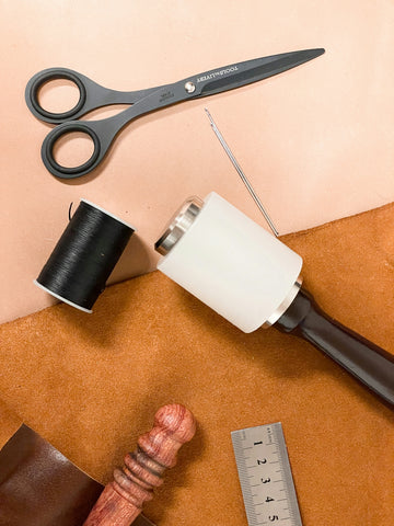 a pair of scissors, a measuring tape, and a pair of scissors on a