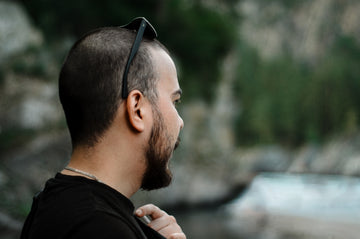 a man with a beard and sunglasses on his head