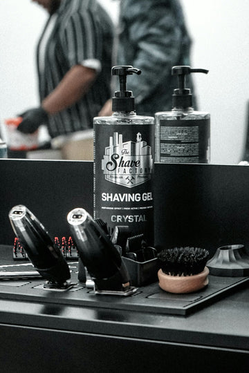 A man in a barber shop getting ready to shave his hair