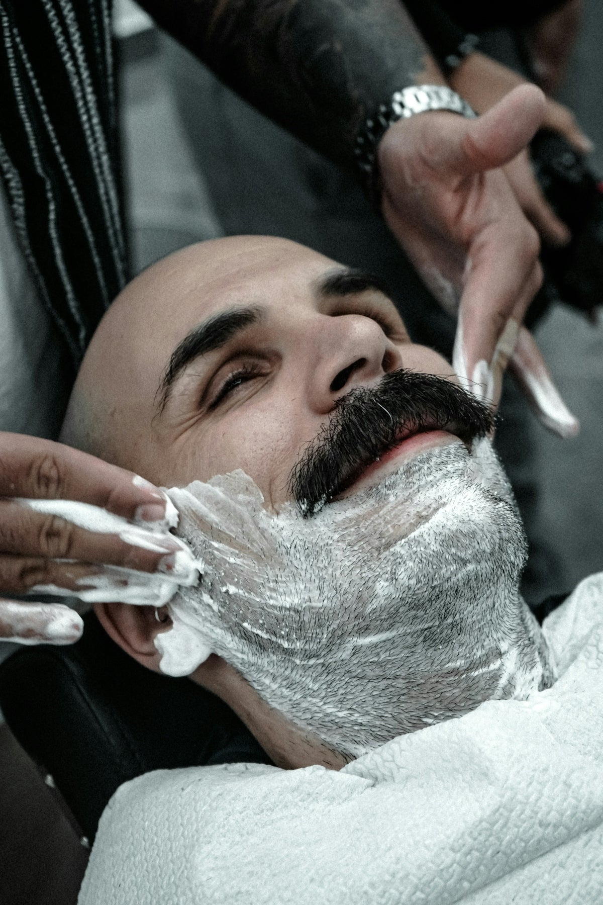 A man getting his hair cut by a barber
